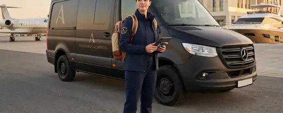 Western-trained paramedic beside a private medical response vehicle at a private aviation and marina facility in the Gulf